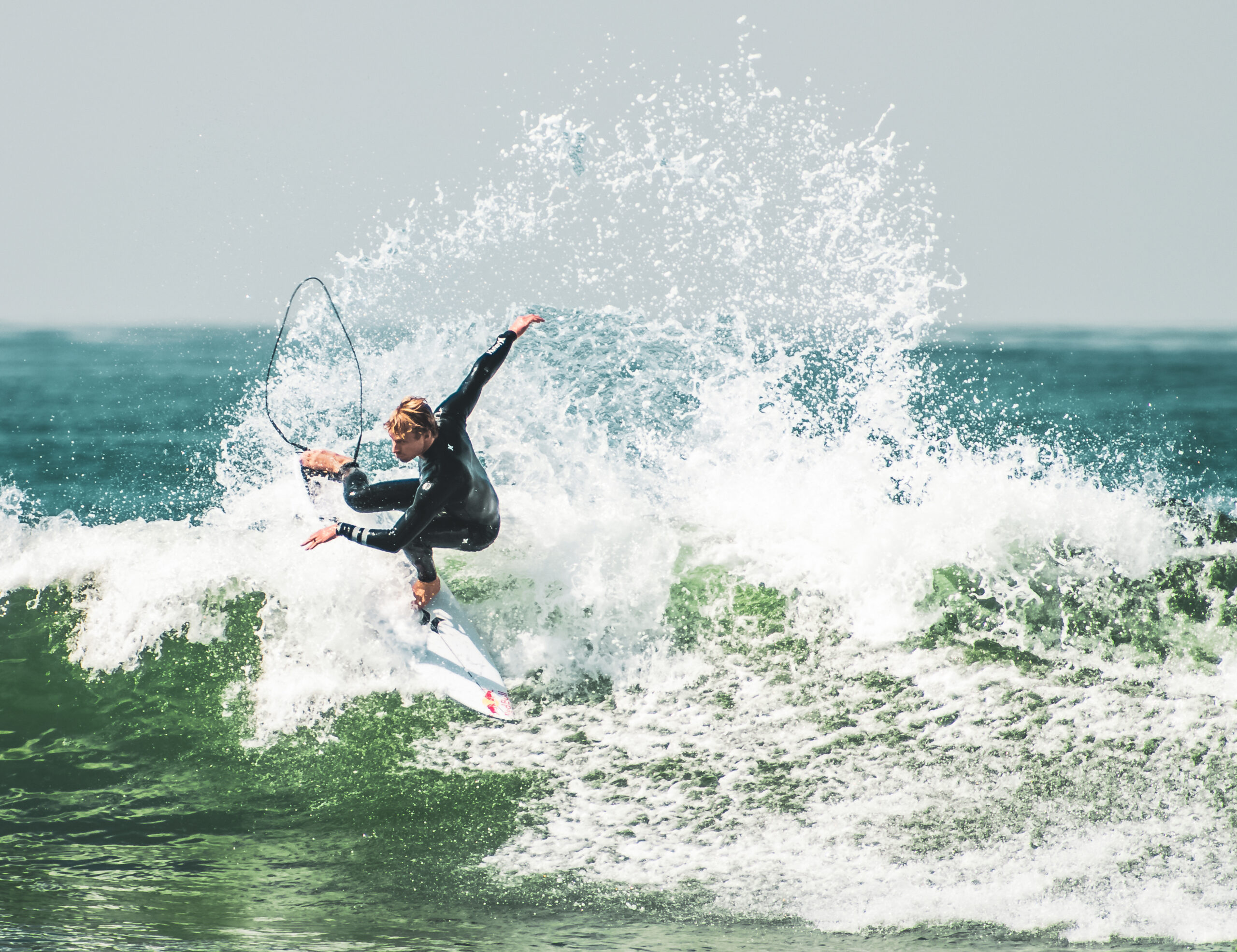 kolohe andino surfing lower trestles, realising the fins and throwing spray. photo by Rob Wessels.