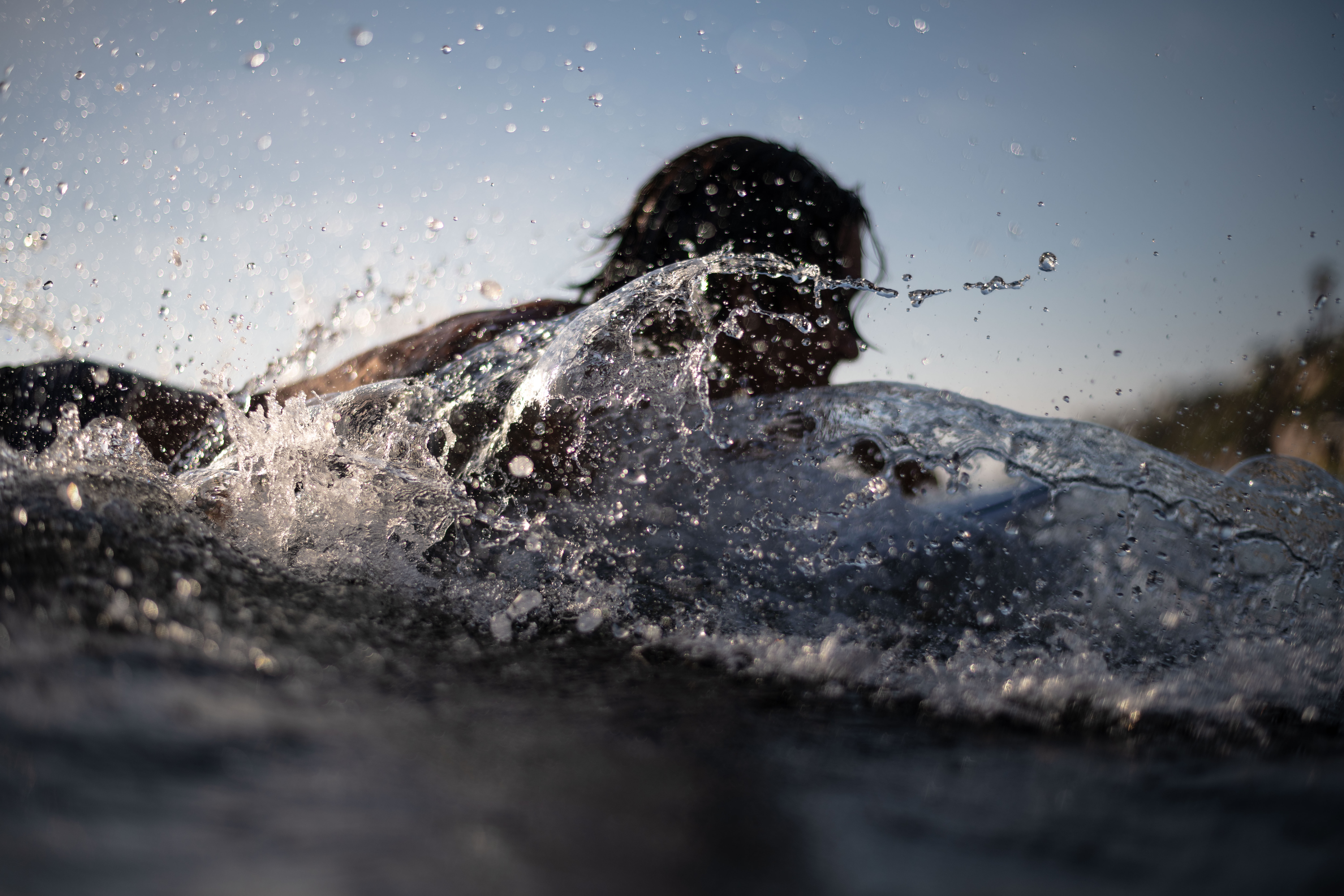 photo of streaking water as a surfer paddles into a wave at Beacons Beach. shot from a in water perspective using my Nikon camera and Aquatech waterproof housing.