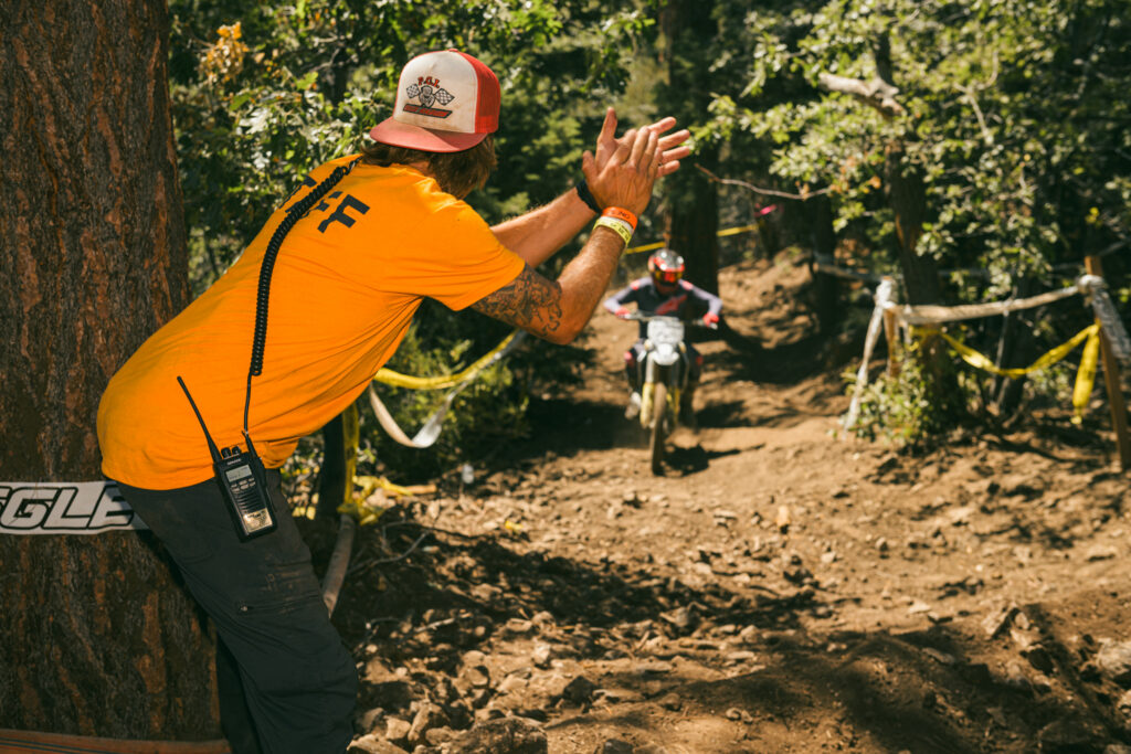 staff at the big bear grand prix cheering on a motocross racer