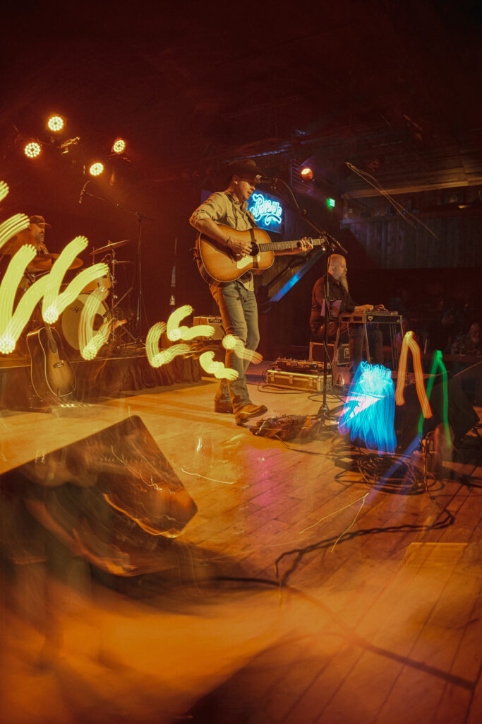 stylized blurry lights over a photo of a guitar player 