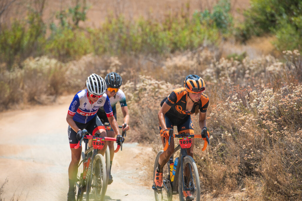 3 professional female gravel cyclist competing in a gravel cycling race in San Diego by Lake Hodges. Photo by Rob Wessels cycling photography