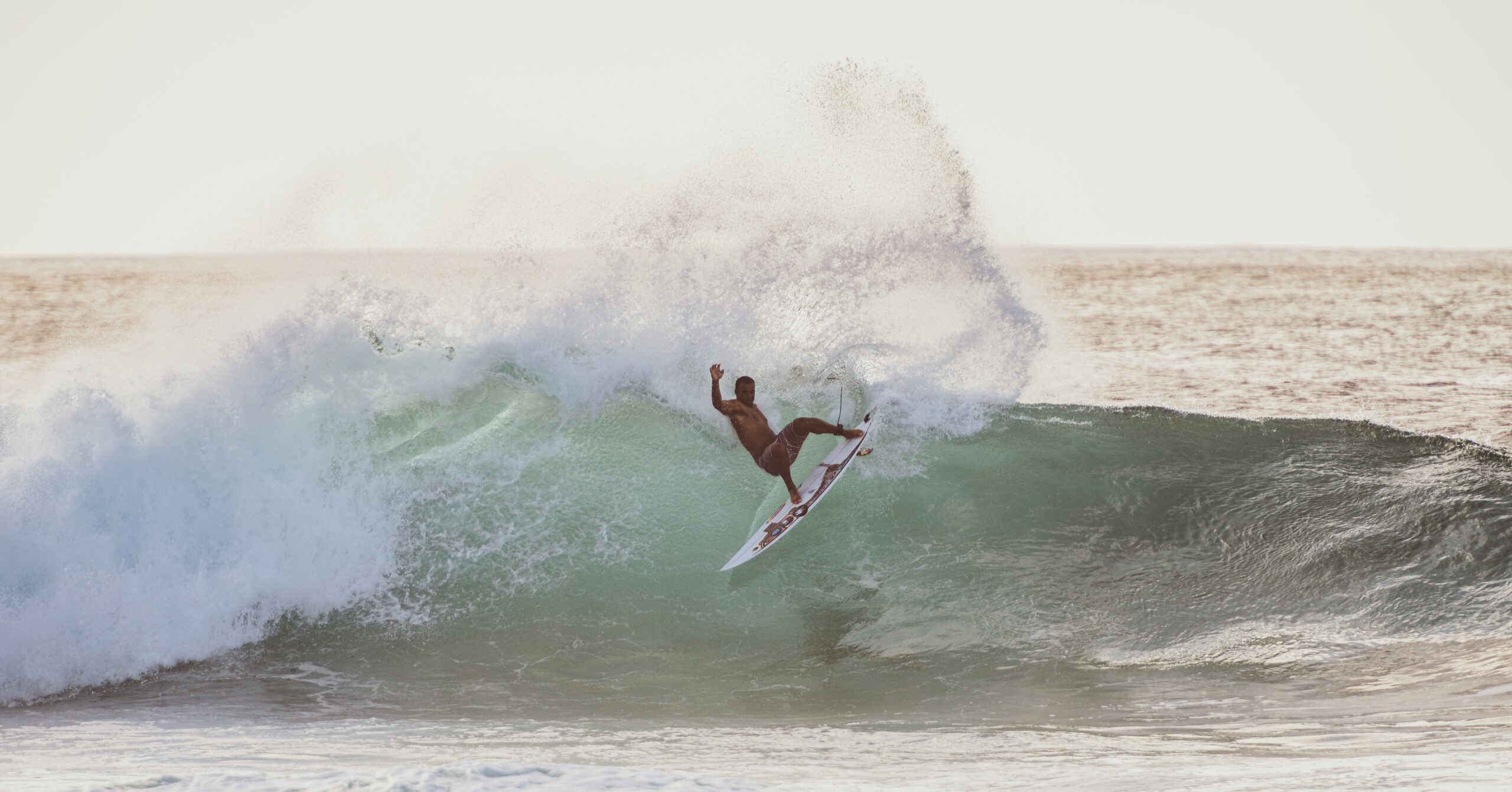 wiggolly dantas  performing a lay back cut back at the Bonzai Pipeline on the north shore of Oahu. Photo by Rob Wessels