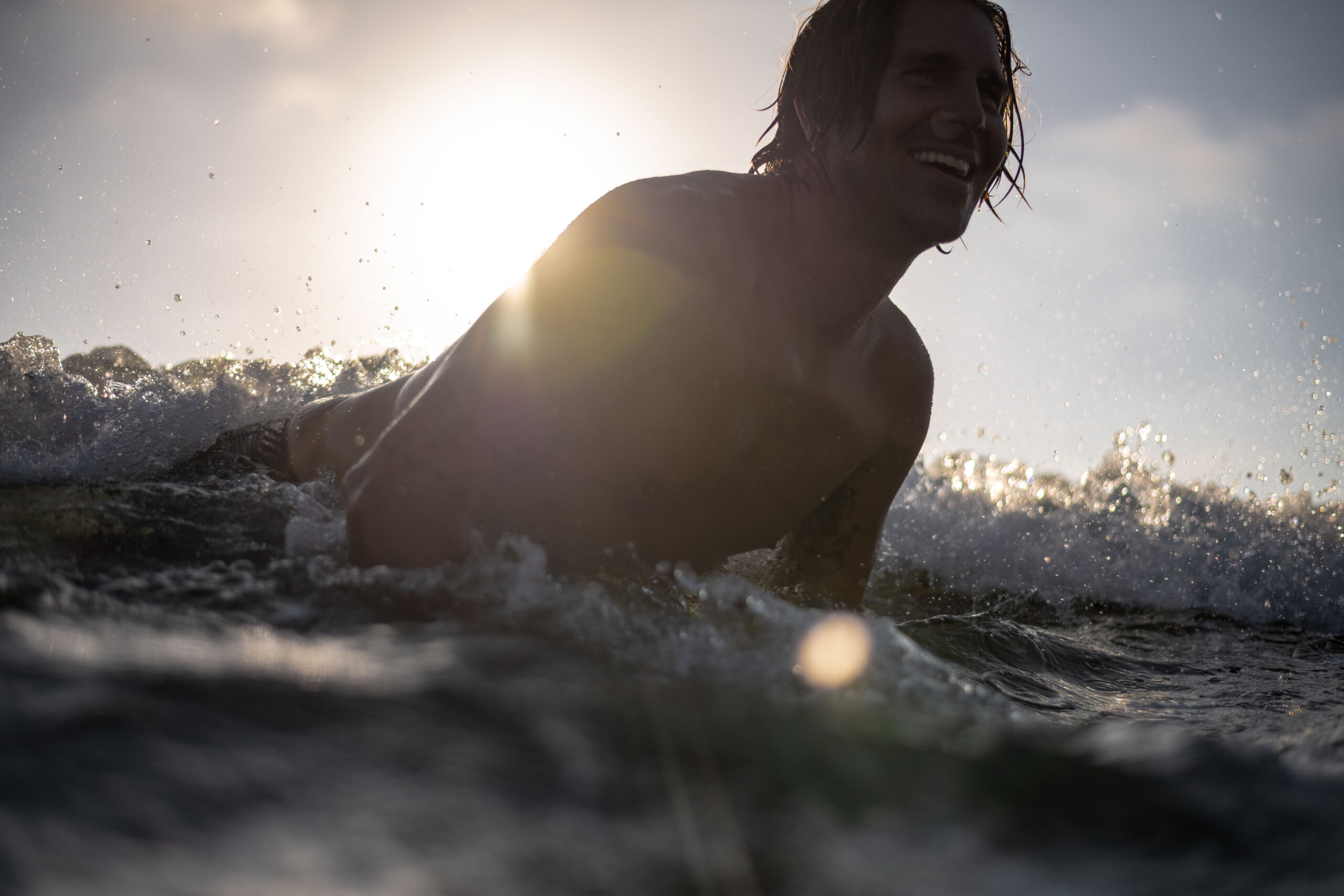 Surfer with the sun behind him, surfing at Beacons beach in Encinitas. Water angle photo shot with my Nikon Camera and Aquatech waterproof housing.