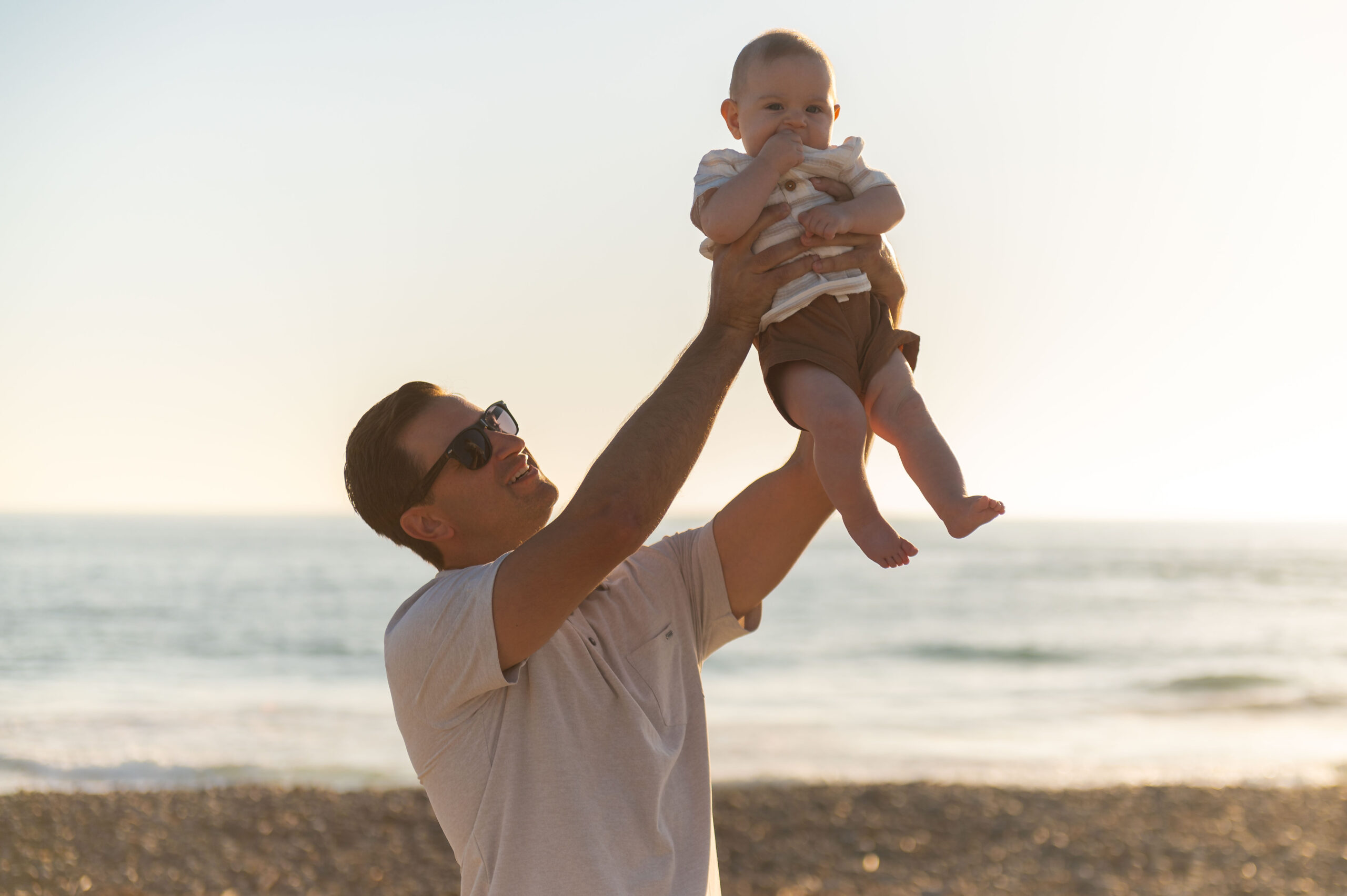 father holding his son up during a family photo session.