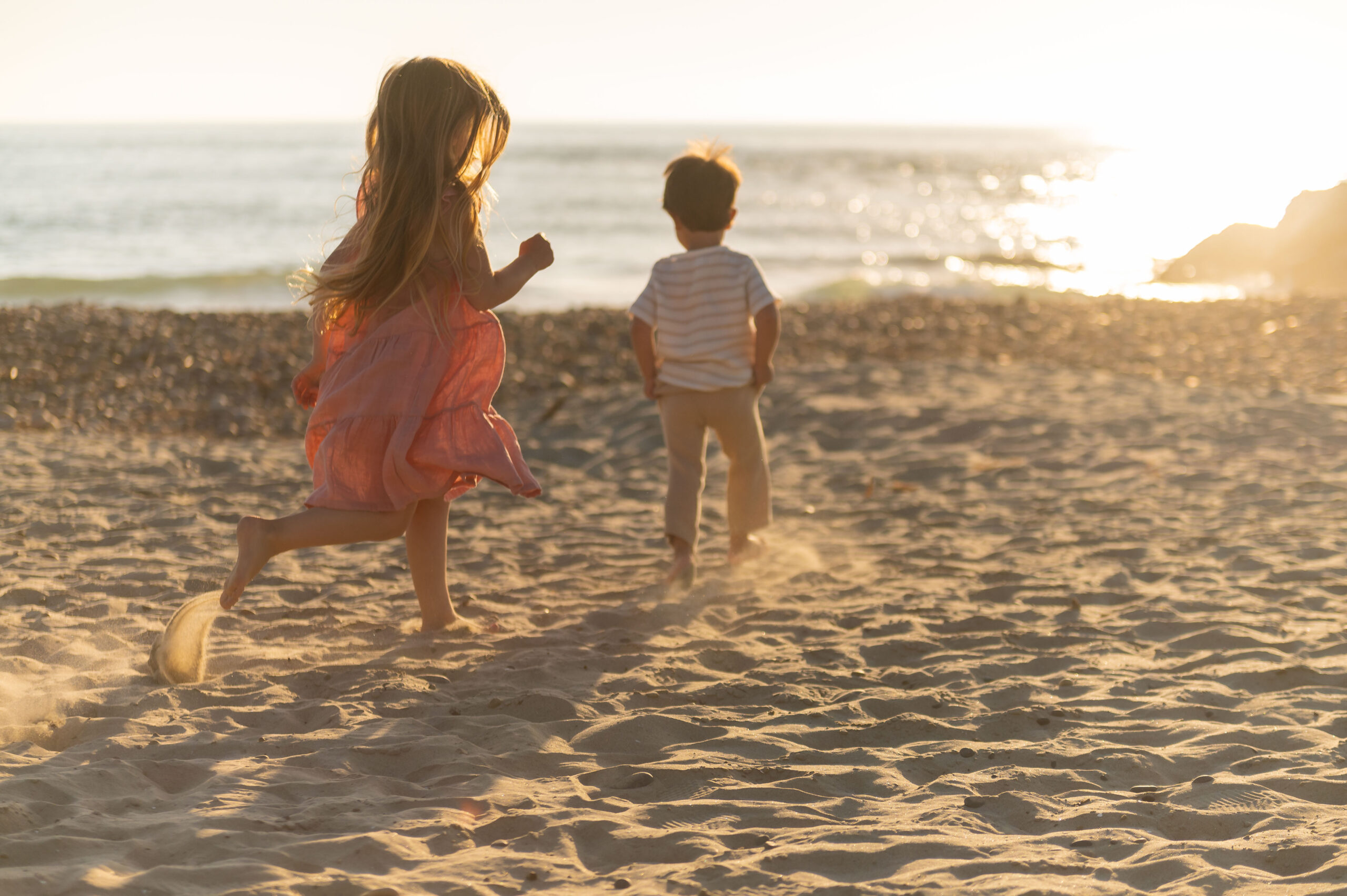 kids playing during Family photos at south carlsbad state beach on a clear summer afternoon