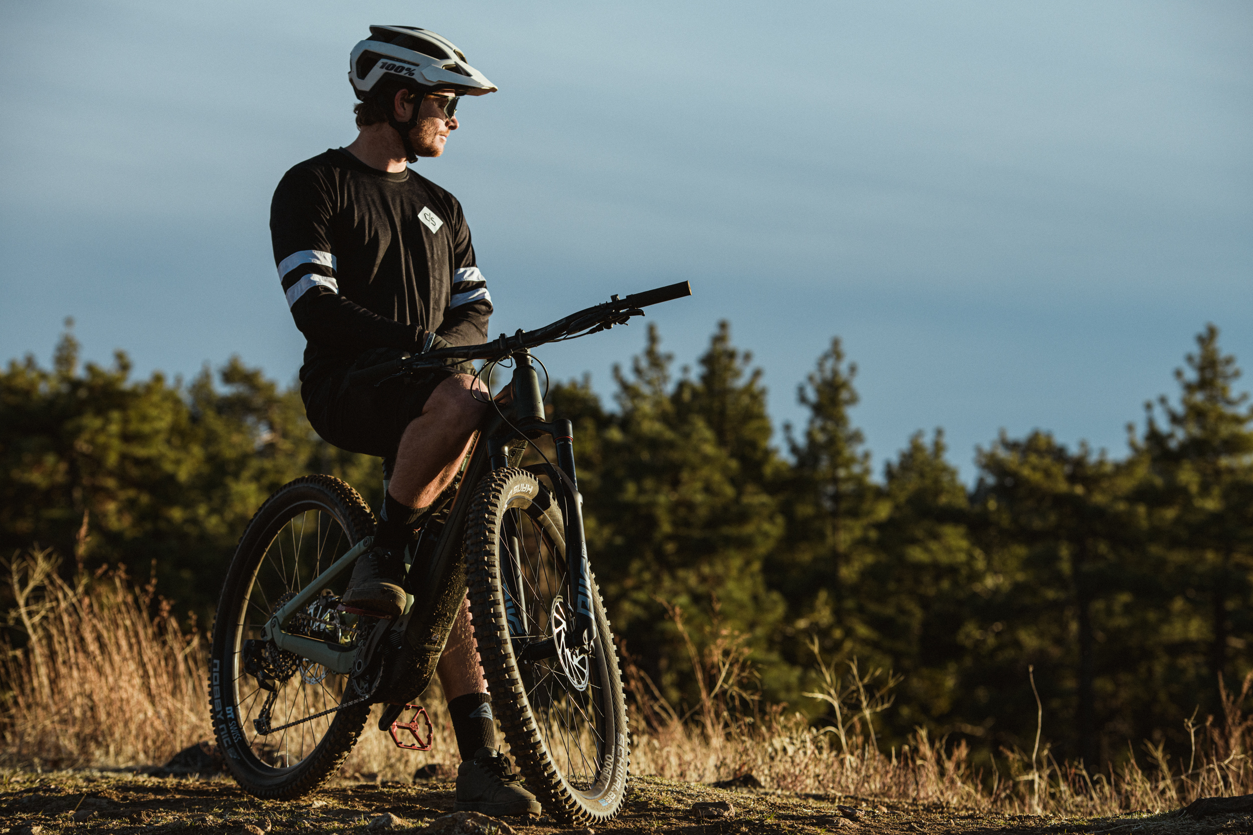 Commercial cyclist riding a Canyon gravel bike through California mountains during a brand campaign.